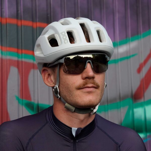 Male cyclist wearing gold mirror cycling glasses that ensure contrast-enhancing vision and high UV protection.