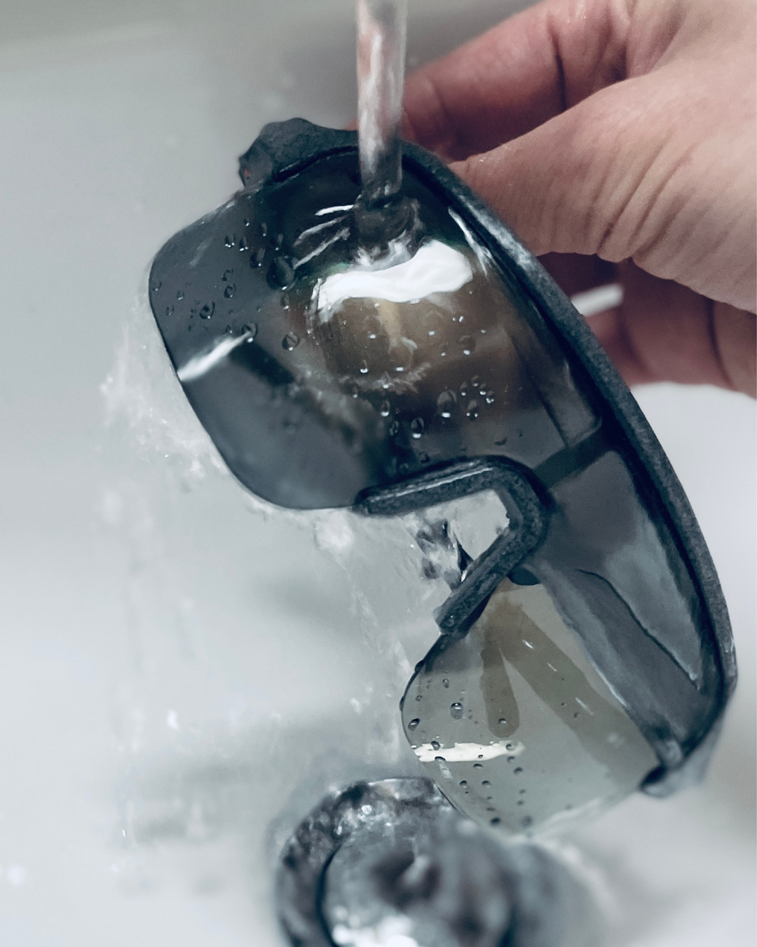 Sports glasses rinsed under running water